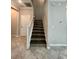 View of a staircase with wood treads and white risers, complemented by tile flooring at 6244 English Hollow Rd, Tampa, FL 33647