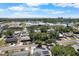 Aerial view showcases a neighborhood with nearby community buildings and city skyline at 6307 S Cameron Ave, Tampa, FL 33616