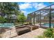 Backyard featuring a brick-paved area, raised garden beds, screened in pool area and a shed at 6307 S Cameron Ave, Tampa, FL 33616