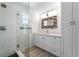 Updated bathroom showcasing a glass shower, vanity, and neutral finishes at 6307 S Cameron Ave, Tampa, FL 33616