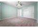 Comfortable bedroom with carpet flooring, ceiling fan, and sliding-door closet at 6307 S Cameron Ave, Tampa, FL 33616