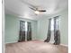 Cozy bedroom with neutral carpet, ceiling fan, and soft natural light at 6307 S Cameron Ave, Tampa, FL 33616