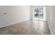 Bright bedroom features tile floors and sliding glass doors leading to a screened pool at 6307 S Cameron Ave, Tampa, FL 33616