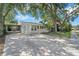 Charming single-story home with mature trees, long driveway, and a screened in porch at 6307 S Cameron Ave, Tampa, FL 33616