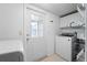 Clean laundry room with new appliances, ample shelving, and a bright window at 6307 S Cameron Ave, Tampa, FL 33616