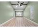 Spacious living room features a bay window, ceiling fan, and wood floors at 6307 S Cameron Ave, Tampa, FL 33616