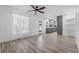 Bright open-concept living area featuring stylish flooring and seamless kitchen access at 6307 S Cameron Ave, Tampa, FL 33616