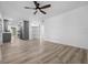 Bright open-concept living area featuring stylish flooring, modern ceiling fan, and seamless kitchen access at 6307 S Cameron Ave, Tampa, FL 33616