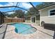 Beautiful kidney shaped pool with a screened enclosure, complemented by a brick-paved patio at 6307 S Cameron Ave, Tampa, FL 33616