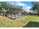 Screened in pool area and spacious backyard, perfect for relaxation and entertainment at 6307 S Cameron Ave, Tampa, FL 33616