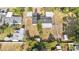 This is an aerial view of a home with a dark roof, a large backyard, and a white fence surrounding the property at 6811 N Himes Ave, Tampa, FL 33614