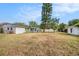 Spacious backyard with a large shade tree, privacy fence, and shed at 6811 N Himes Ave, Tampa, FL 33614