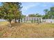 View of the large screened in porch from the backyard of this cozy single Gathering home at 6811 N Himes Ave, Tampa, FL 33614