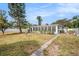 View of the large screened in porch from the backyard of this cozy single Gathering home at 6811 N Himes Ave, Tampa, FL 33614