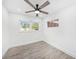 Cozy bedroom with modern ceiling fan, wood-look flooring and lots of natural light at 6811 N Himes Ave, Tampa, FL 33614