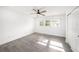 Cozy bedroom with ceiling fan, wood-look floors, and ample natural light at 6811 N Himes Ave, Tampa, FL 33614