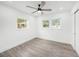 Bright bedroom with wood-look flooring, fresh paint, and a modern ceiling fan at 6811 N Himes Ave, Tampa, FL 33614