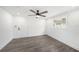 Bright bedroom featuring modern ceiling fan, neutral walls, and gray wood-look flooring at 6811 N Himes Ave, Tampa, FL 33614