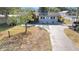 A beautiful single-story home with an attached garage, updated exterior, and well manicured lawn at 6811 N Himes Ave, Tampa, FL 33614