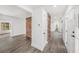 Bright hallway with wood-look floors, fresh white paint, brick accents, and multiple access points at 6811 N Himes Ave, Tampa, FL 33614