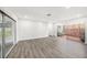 Bright, open living room with a sliding glass door and stylish wood-look flooring at 6811 N Himes Ave, Tampa, FL 33614