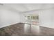 Open living room with gray flooring and sliding glass doors to screened porch at 6811 N Himes Ave, Tampa, FL 33614