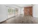 Open-concept living room with wood-look floors and a large sliding glass door at 6811 N Himes Ave, Tampa, FL 33614