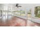 Bright sun room features tile flooring, ceiling fans and large windows overlooking the backyard at 6811 N Himes Ave, Tampa, FL 33614