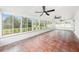 Bright sun room features tile flooring, ceiling fans and large windows overlooking the backyard at 6811 N Himes Ave, Tampa, FL 33614
