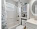 All-white bathroom featuring a shower-tub combo, modern fixtures, and vanity sink at 6816 13Th N St, St Petersburg, FL 33702