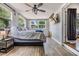 This bedroom features wood floors, a ceiling fan, and windows that bring in natural light at 6816 13Th N St, St Petersburg, FL 33702