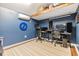 Loft-style bonus room with wood flooring, built-in desks, and a ceiling mounted air conditioner at 6816 13Th N St, St Petersburg, FL 33702