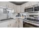 Updated kitchen features sleek countertops, stainless steel appliances, and subway tile backsplash at 6816 13Th N St, St Petersburg, FL 33702
