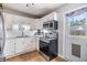 Well-equipped kitchen with stainless steel appliances and white cabinetry offers a clean, functional space at 6816 13Th N St, St Petersburg, FL 33702