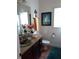 Well-lit bathroom with an undermount sink and colorful decor at 6926 Mccray Dr, Hudson, FL 34667