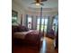 Elegant primary bedroom featuring a four-poster bed and tray ceiling at 6926 Mccray Dr, Hudson, FL 34667