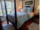 Comfortable bedroom featuring a four post bed and natural lighting at 6926 Mccray Dr, Hudson, FL 34667