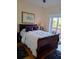 The bedroom features a queen bed and sliding glass doors to the patio at 6926 Mccray Dr, Hudson, FL 34667