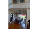 Open-concept dining room features hardwood floors, decorative chandelier, and ample natural light at 6926 Mccray Dr, Hudson, FL 34667