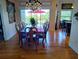 Elegant dining room featuring a chandelier, hardwood floors, and access to the outdoor patio at 6926 Mccray Dr, Hudson, FL 34667