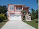Inviting two-story home featuring a two-car garage, landscaped yard, and concrete driveway at 6926 Mccray Dr, Hudson, FL 34667