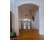 Bright foyer with hardwood floors, archway, chandelier and staircase leading to the upper level at 6926 Mccray Dr, Hudson, FL 34667