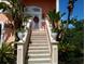 Grand entrance with decorative stairs, flower boxes, and double doors with a wreath at 6926 Mccray Dr, Hudson, FL 34667