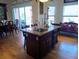 Open-concept kitchen features an island with sink and seating, granite countertops, and wooden cabinets at 6926 Mccray Dr, Hudson, FL 34667