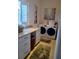 Laundry room with a washer, dryer, and ample counter space at 6926 Mccray Dr, Hudson, FL 34667