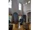 Sunlit living room featuring hardwood floors, high ceilings, and stylish furnishings at 6926 Mccray Dr, Hudson, FL 34667