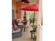 Inviting outdoor seating area with red umbrella and comfortable wicker furniture at 6926 Mccray Dr, Hudson, FL 34667