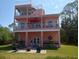 Multi-story home featuring balconies, patio, outdoor seating, and a private backyard oasis at 6926 Mccray Dr, Hudson, FL 34667