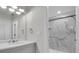 Modern bathroom featuring marble-look walk-in shower, ample counter space, and updated fixtures at 7360 Ulmerton Rd # 17D, Largo, FL 33771