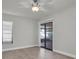 Bedroom with wood-look floors, neutral walls, and a sliding glass door leading to the patio at 7360 Ulmerton Rd # 17D, Largo, FL 33771